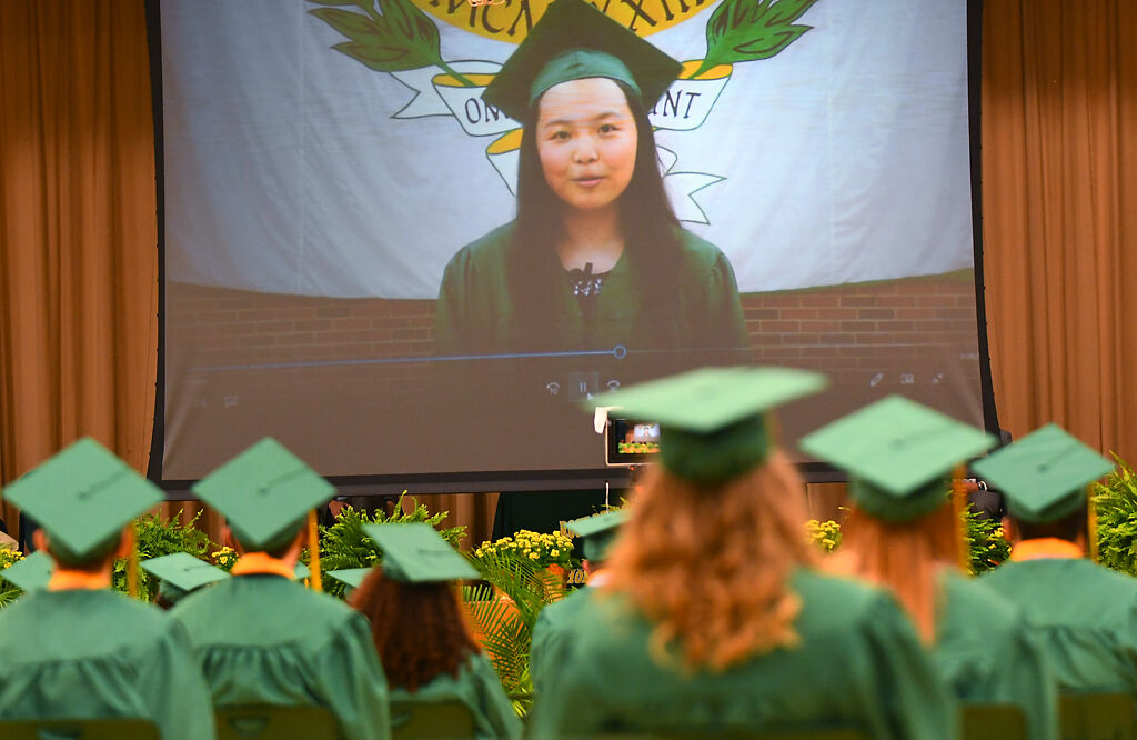 Anna Xu addresses commencement via video while students are watching